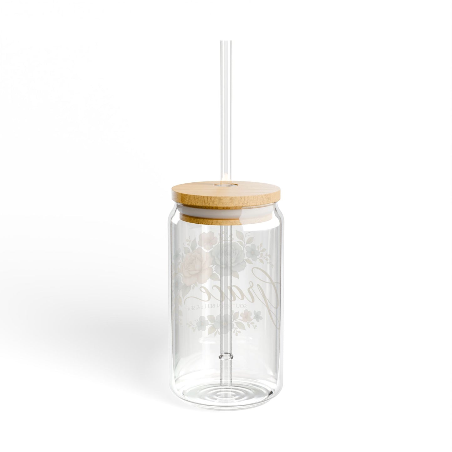 Clear glass tumbler with a wooden lid and straw on a white background