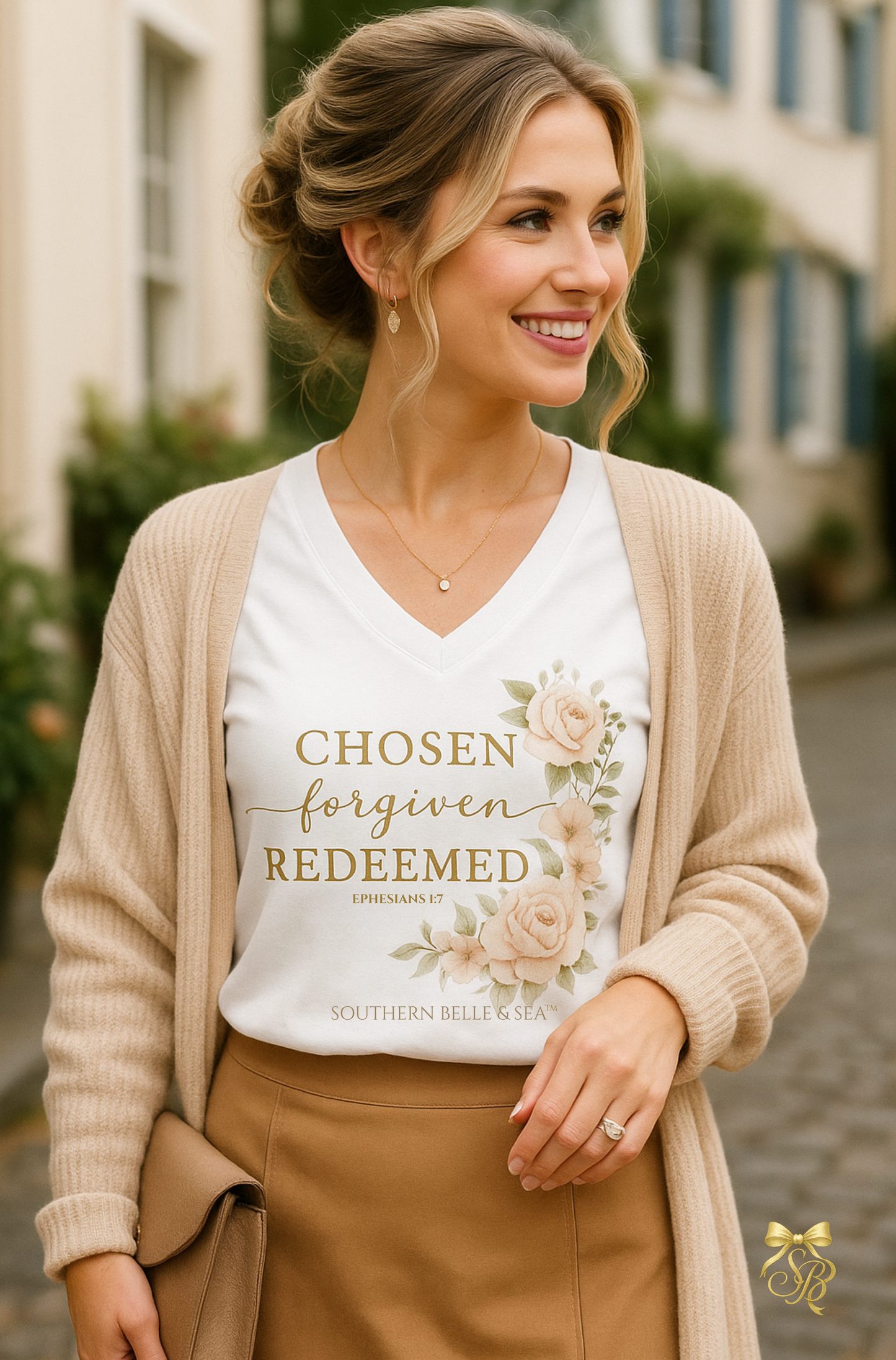 Woman wearing a white t-shirt with text and floral design, standing outdoors.