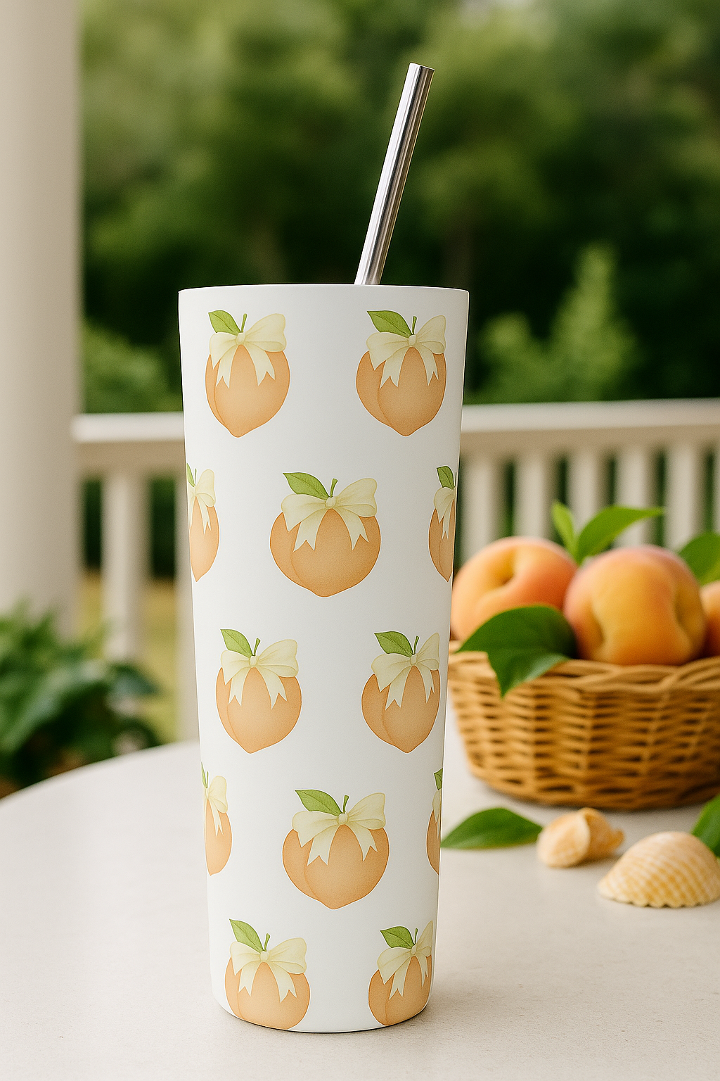 20 oz stainless steel tumbler with repeating peach-and-bow pattern on a white porch rail, lid and metal straw included.