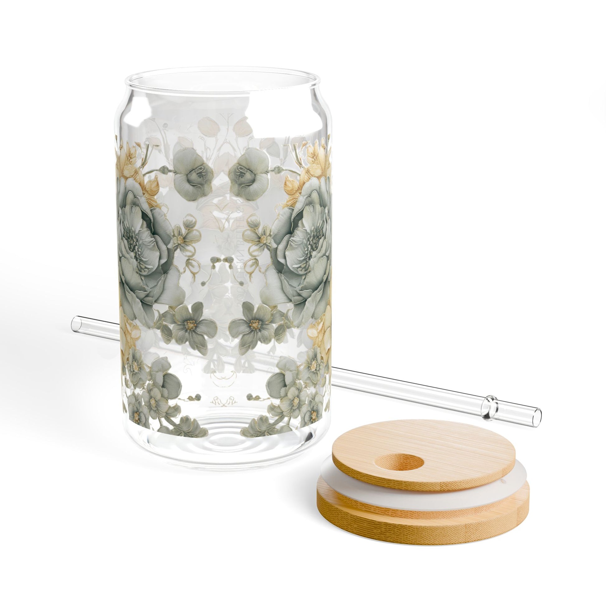 Clear glass tumbler with floral design, wooden coasters, and a straw on a white background
