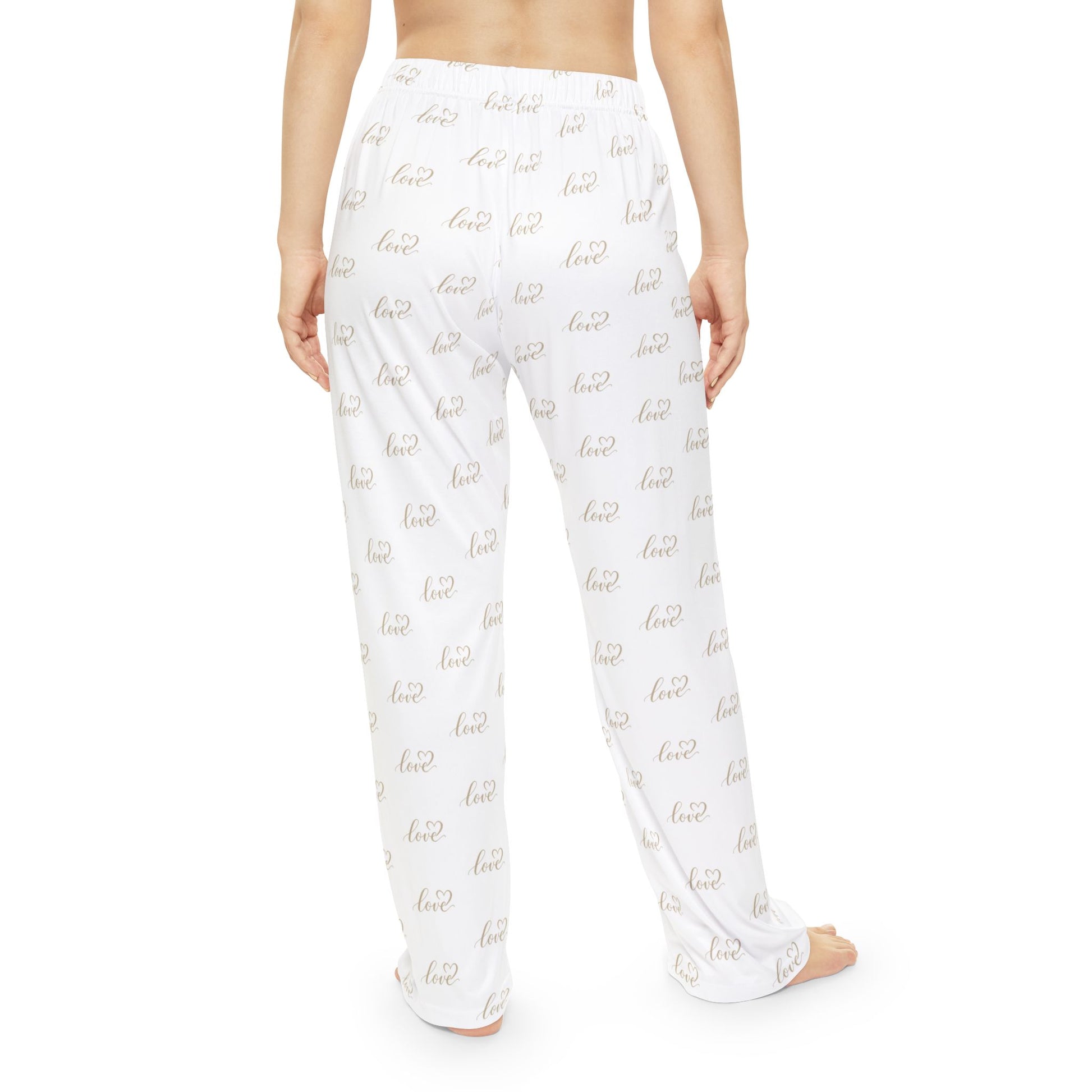 White pajama pants with gold love text pattern on a white background