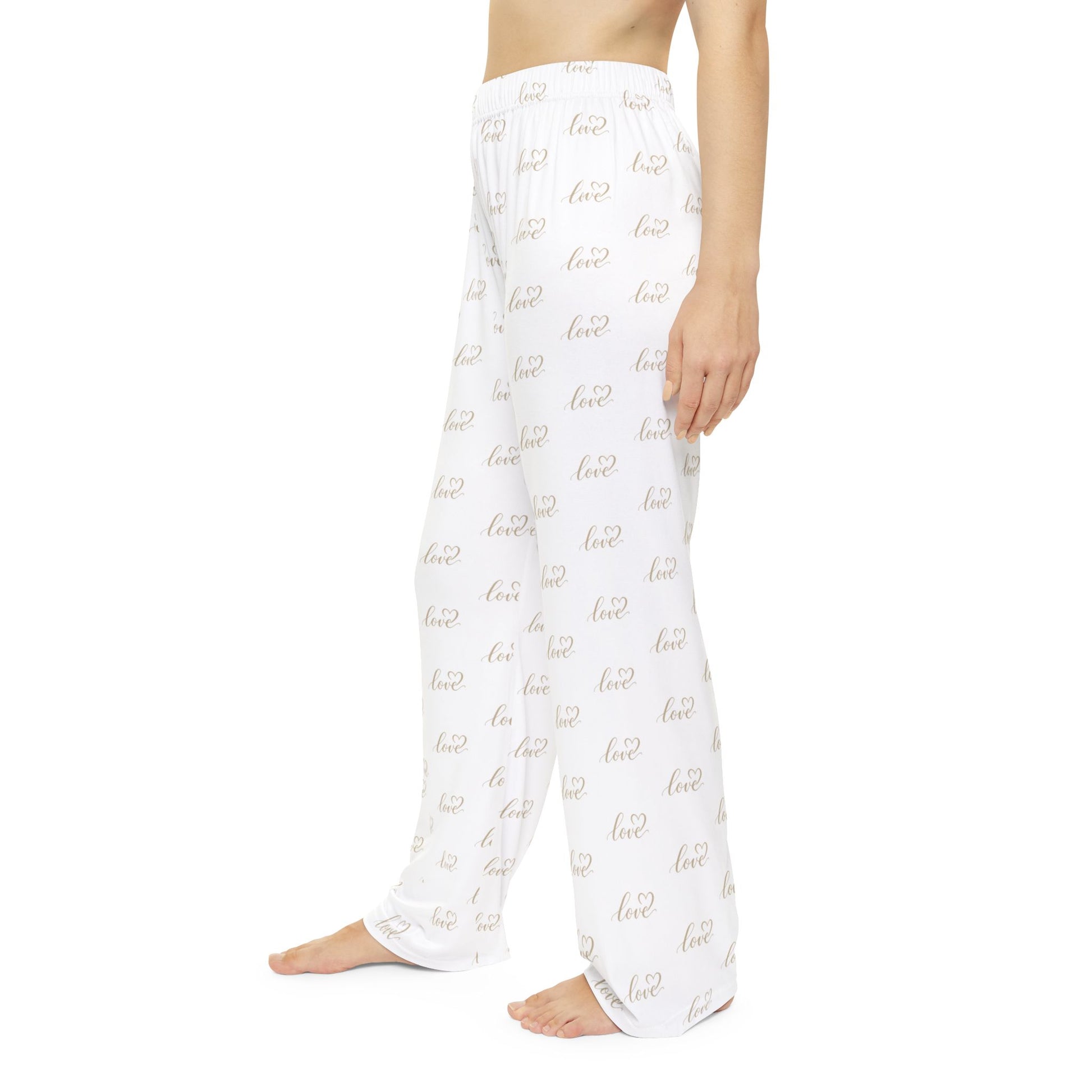 White pajama pants with gold text pattern on a white background