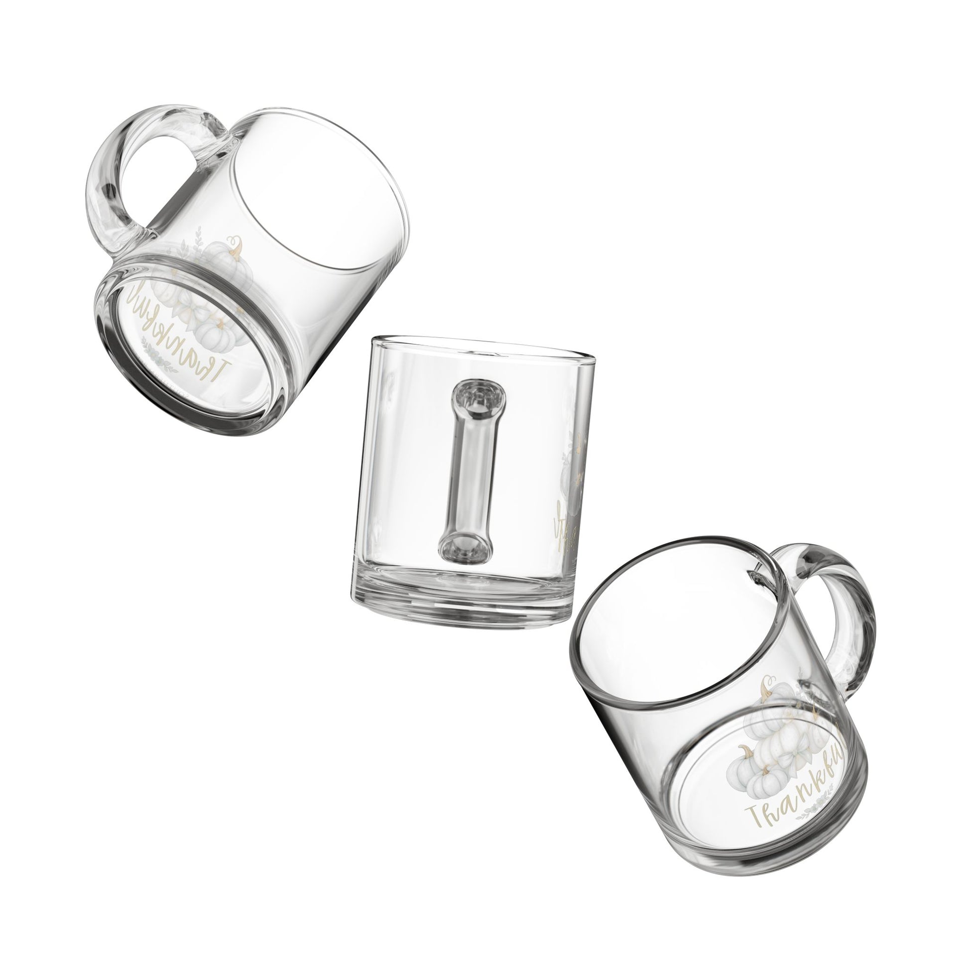 Set of three clear glass mugs with handles on a white background