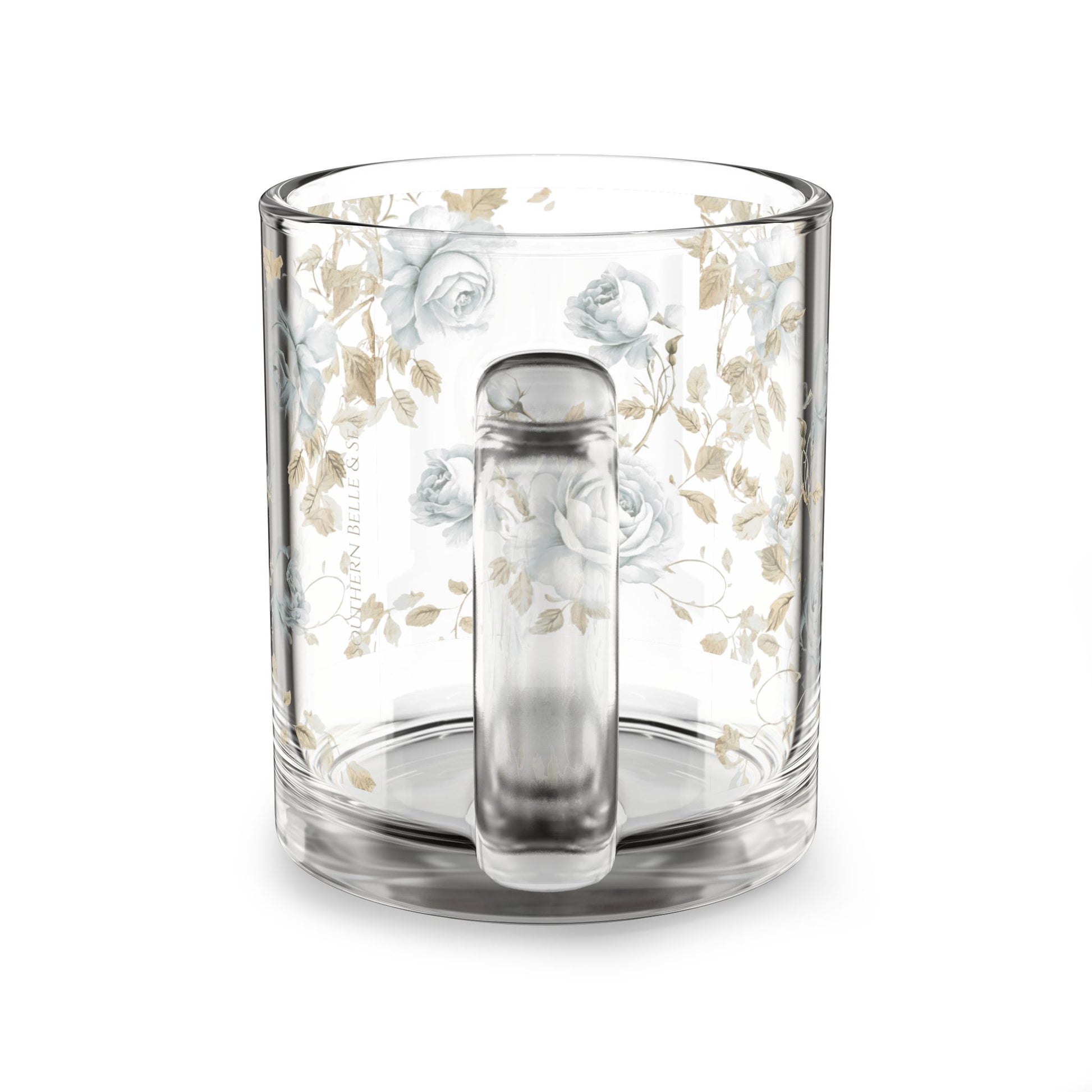 Clear glass mug with floral design and tea infuser on a white background