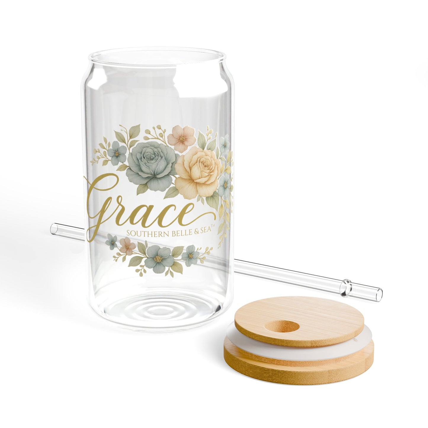Glass tumbler with floral design, straw, and coasters on a white background
