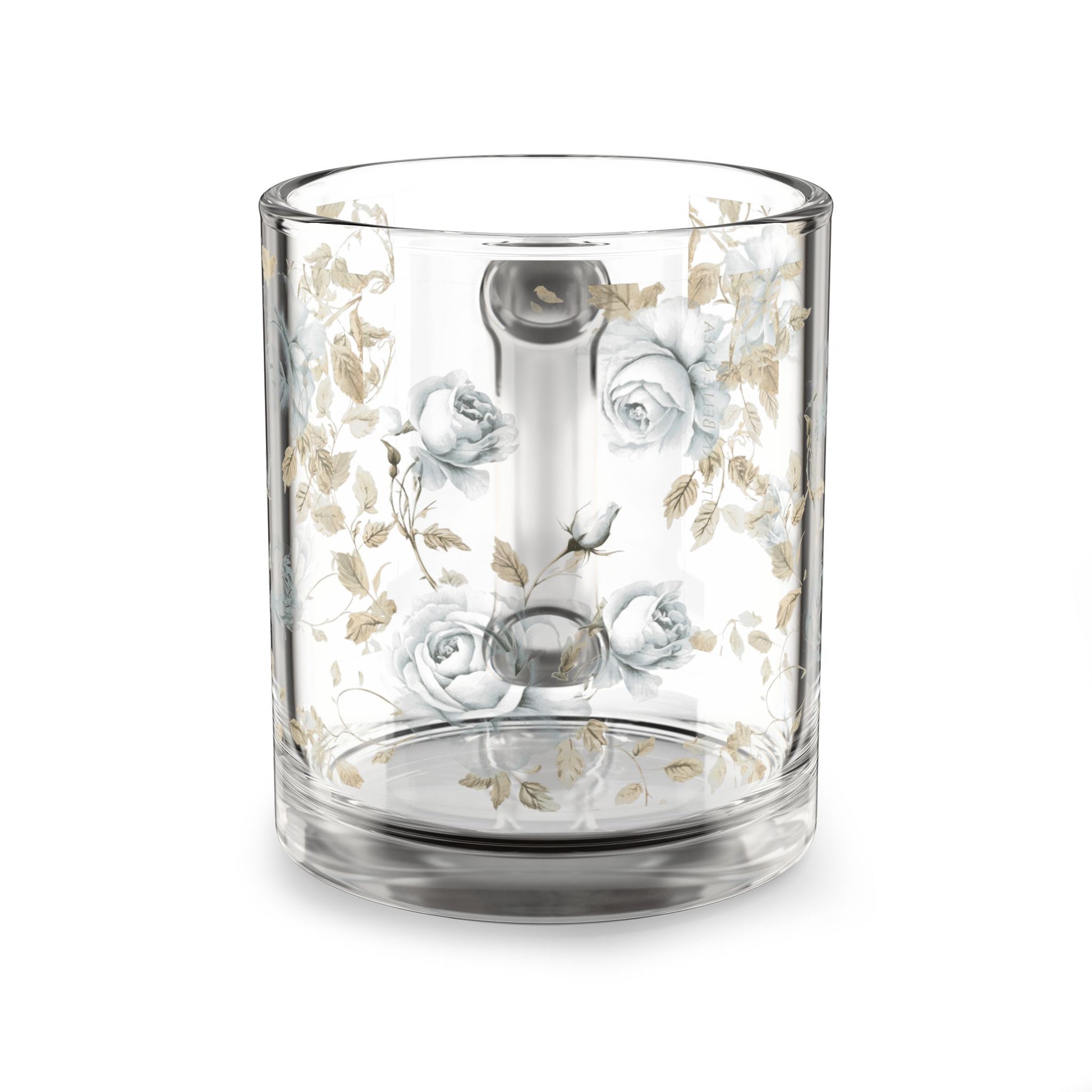 Clear glass tumbler with floral design on a white background