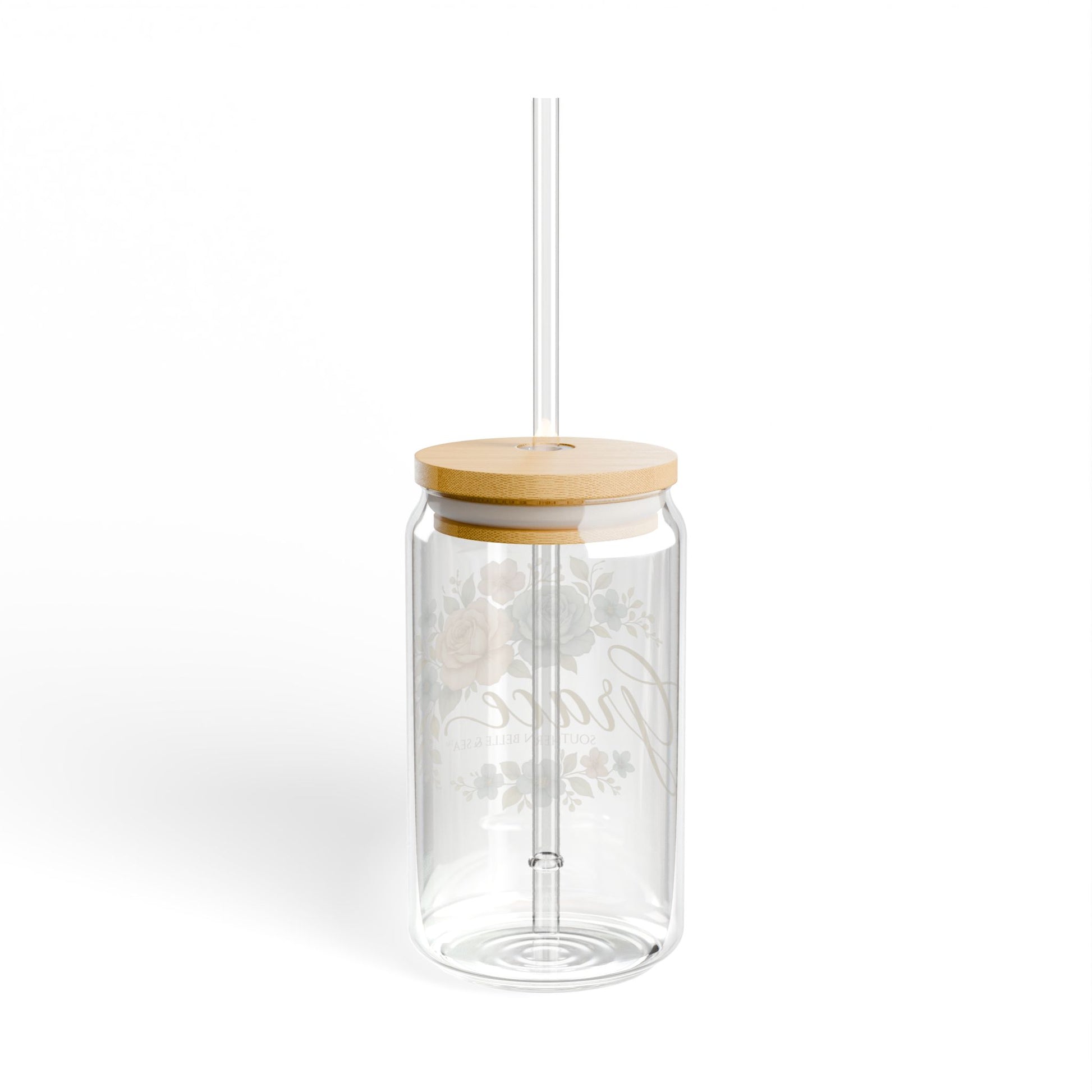 Clear glass tumbler with a wooden lid and straw on a white background