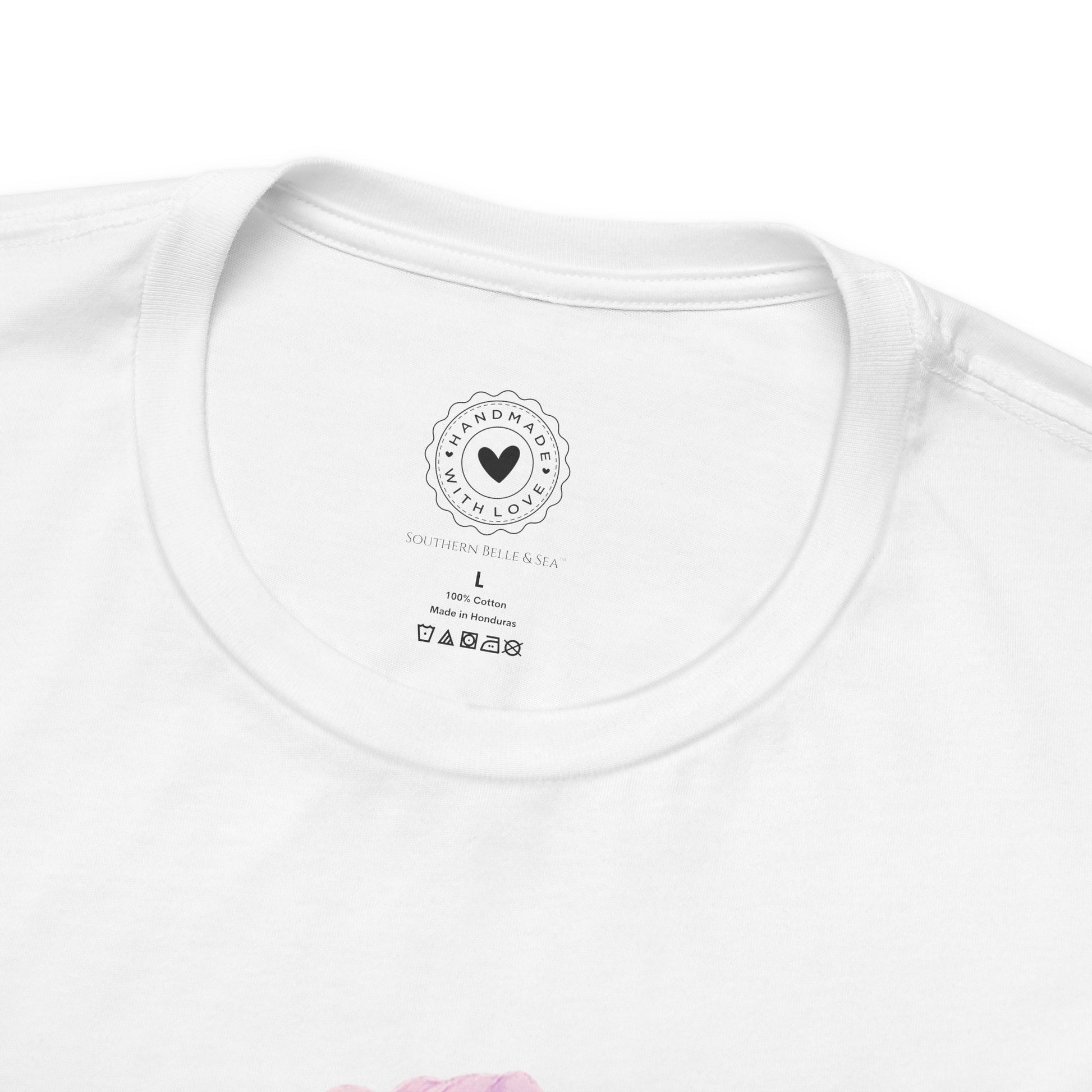 Close-up of a white t-shirt with a southern belle and sea logo and text on the collar.