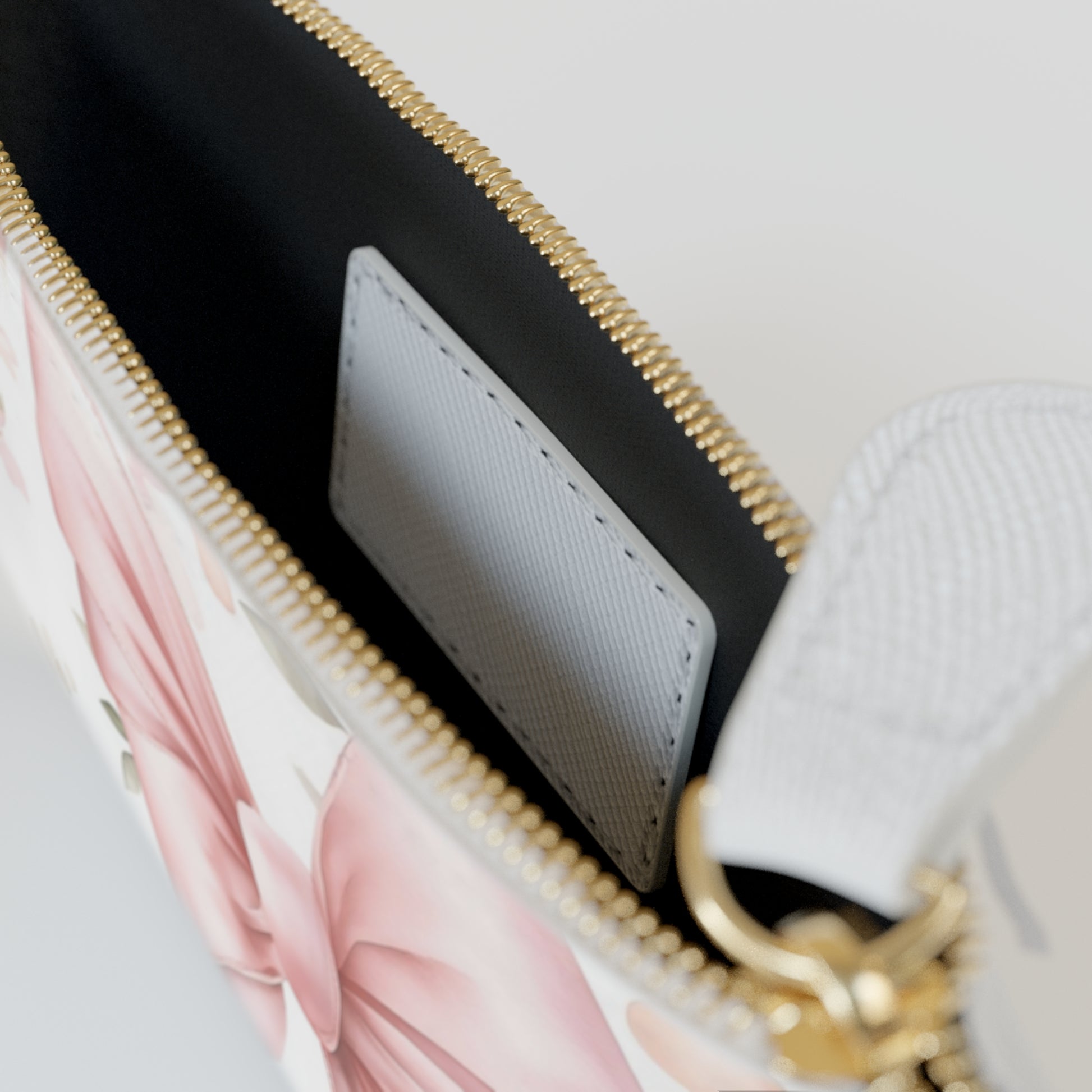 Close-up of a floral-patterned handbag with a gold zipper.
