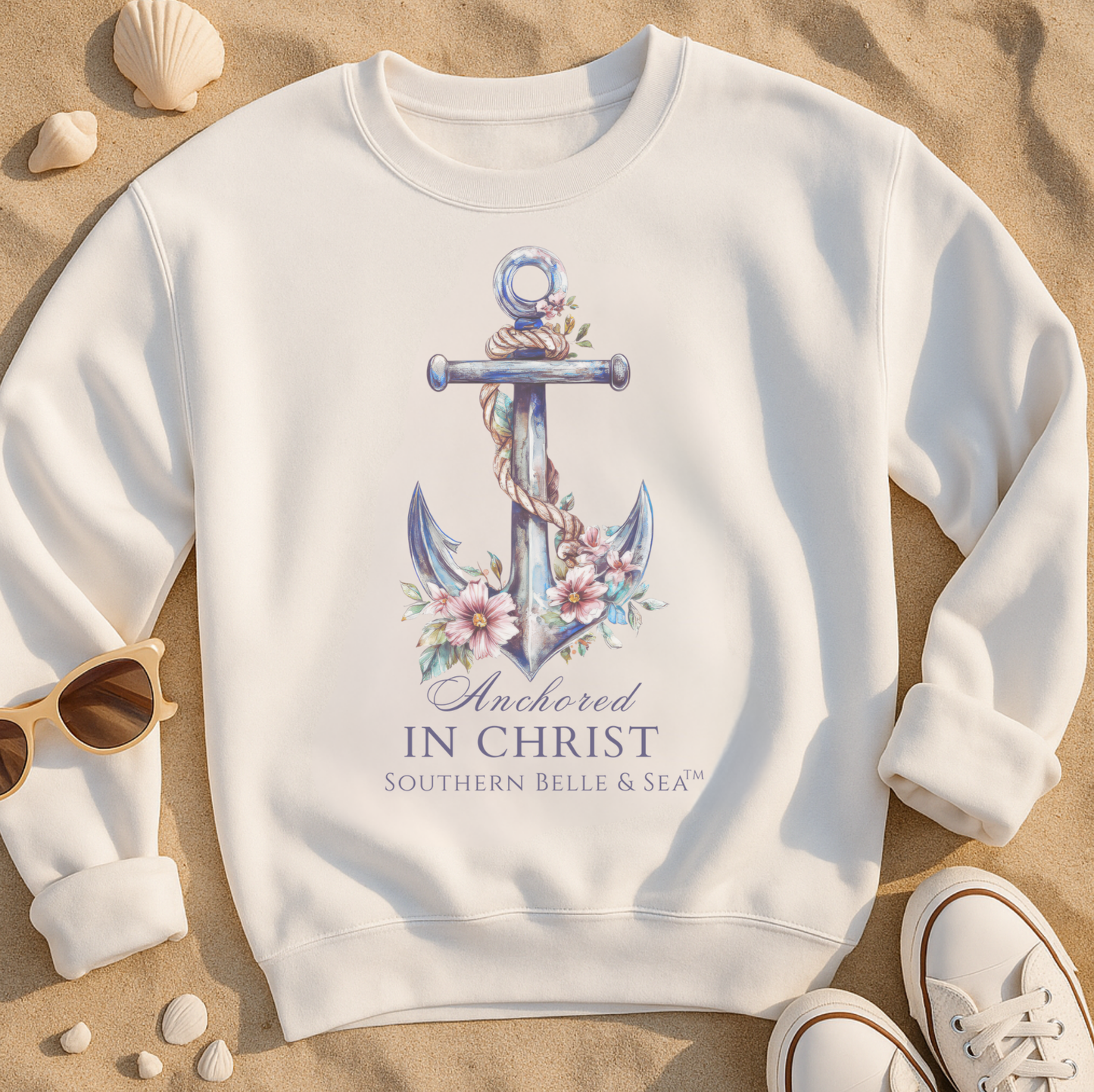 White ANCHORED IN CHRIST CHRISTIAN BEACHWARE sweatshirt with anchor design and text on a sandy background