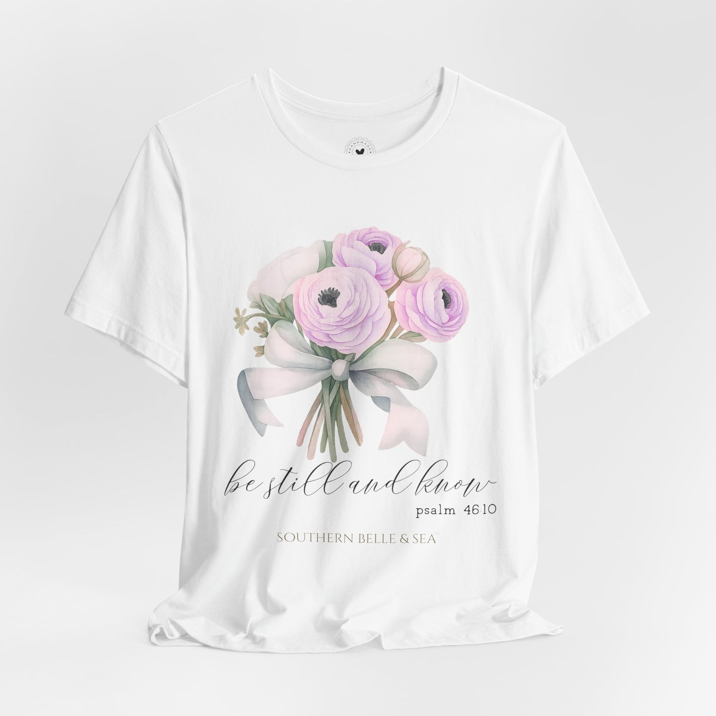 Be Still and Know floral Christian tee styled with jeans and flowers soft cream color