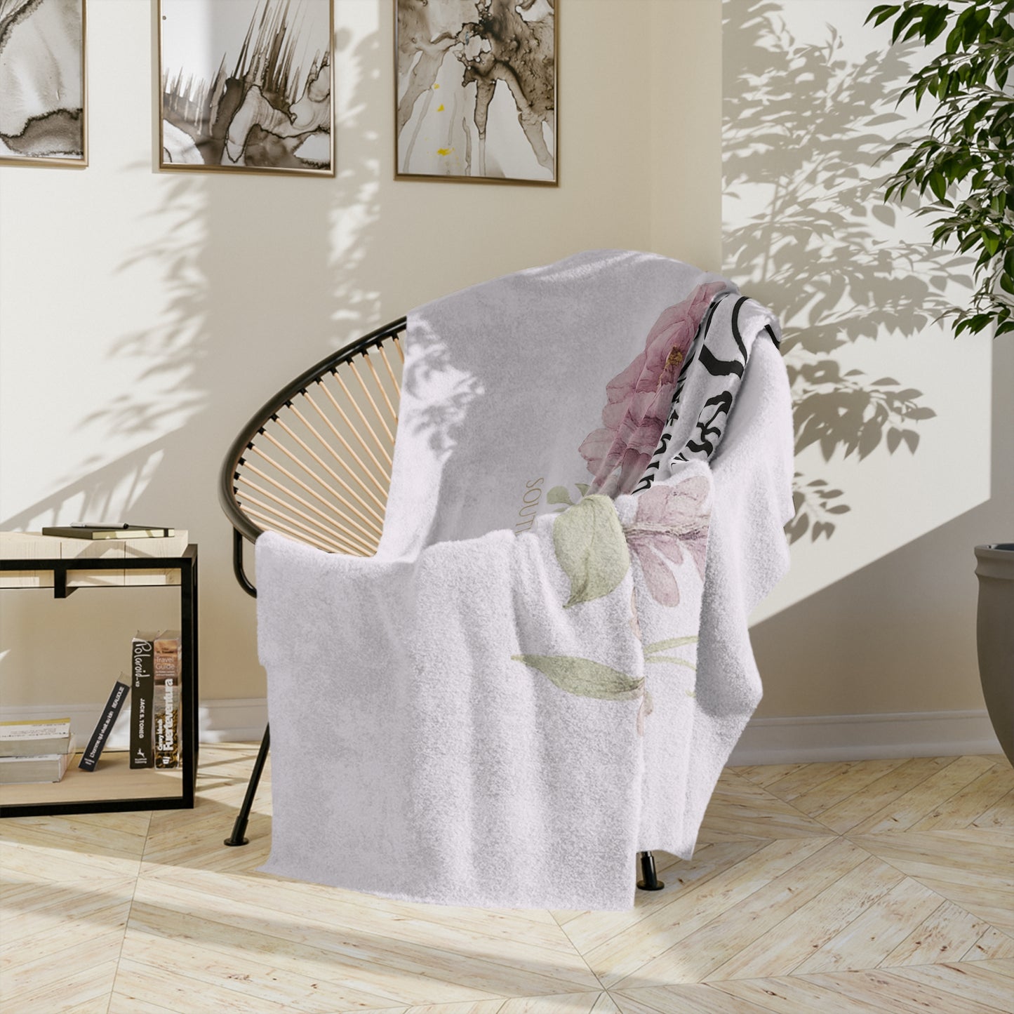Floral-patterned blanket draped over a chair in a room with light-colored walls and decor.