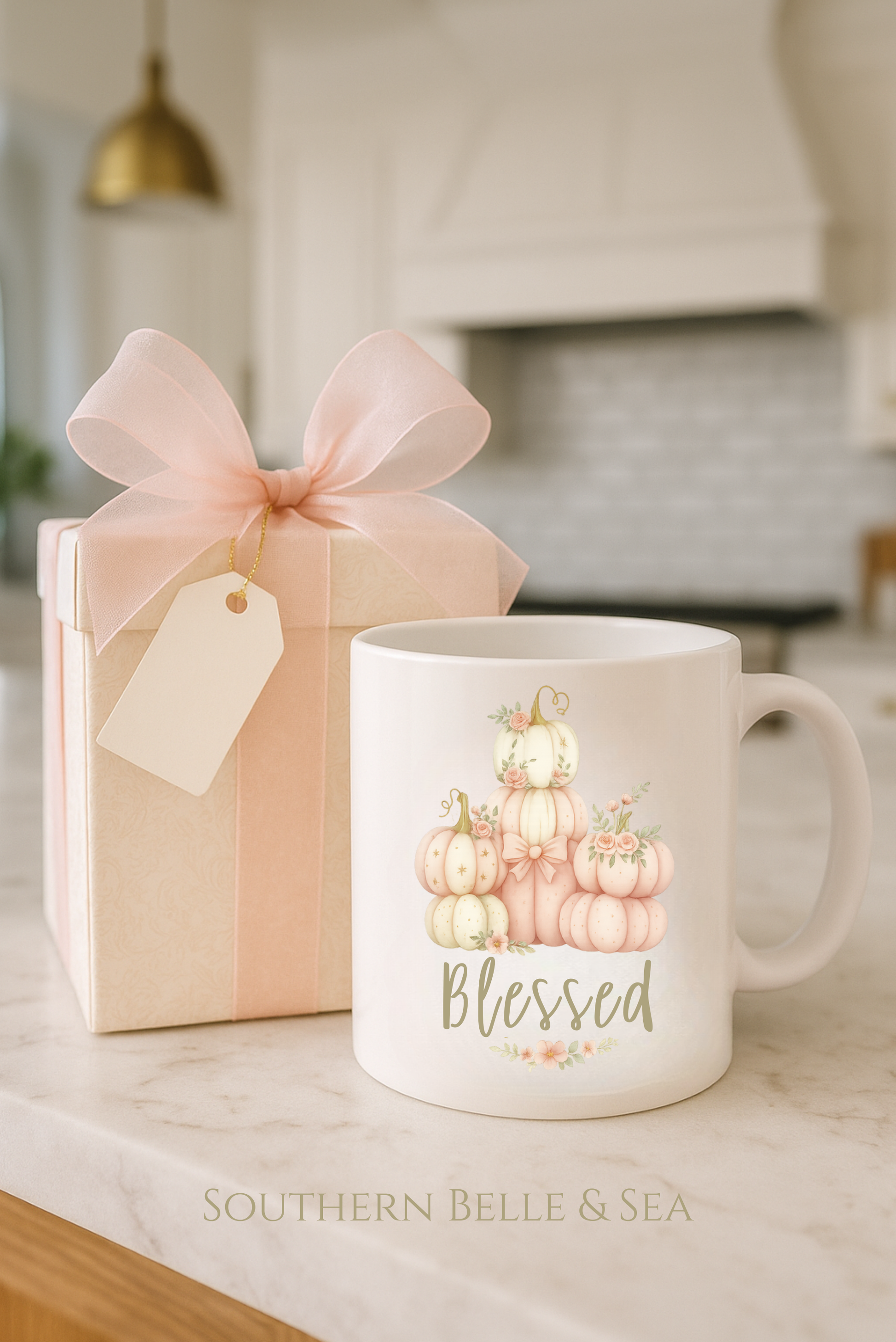 Mug with pumpkin design and 'Blessed' text next to a gift box on a kitchen counter.