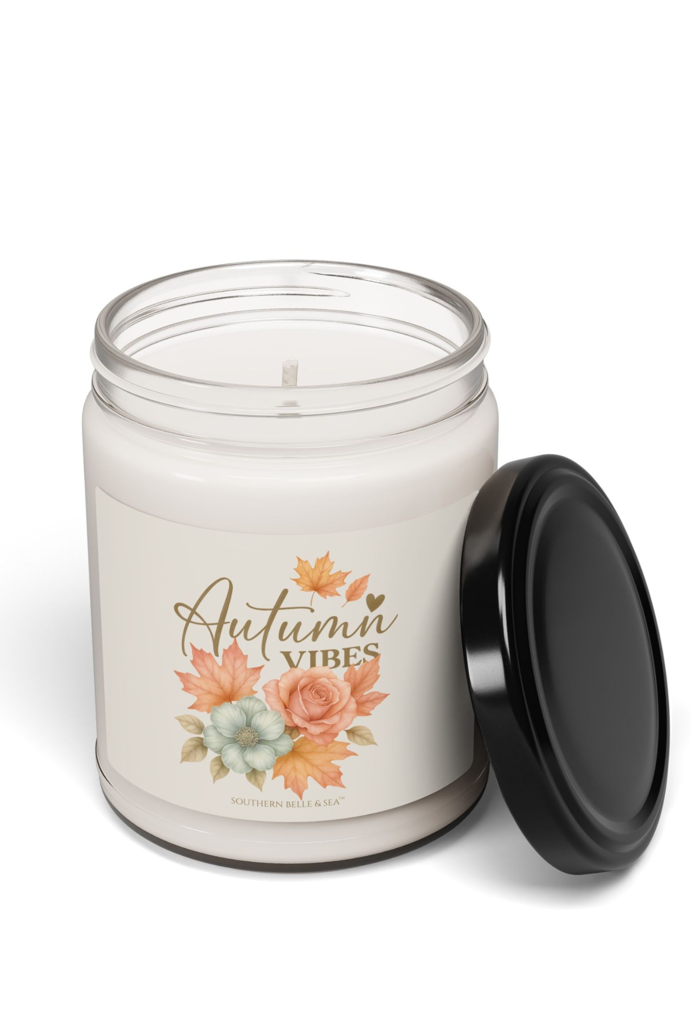 Candle in a jar with 'Autumn Vibes' label featuring floral design on a white background
