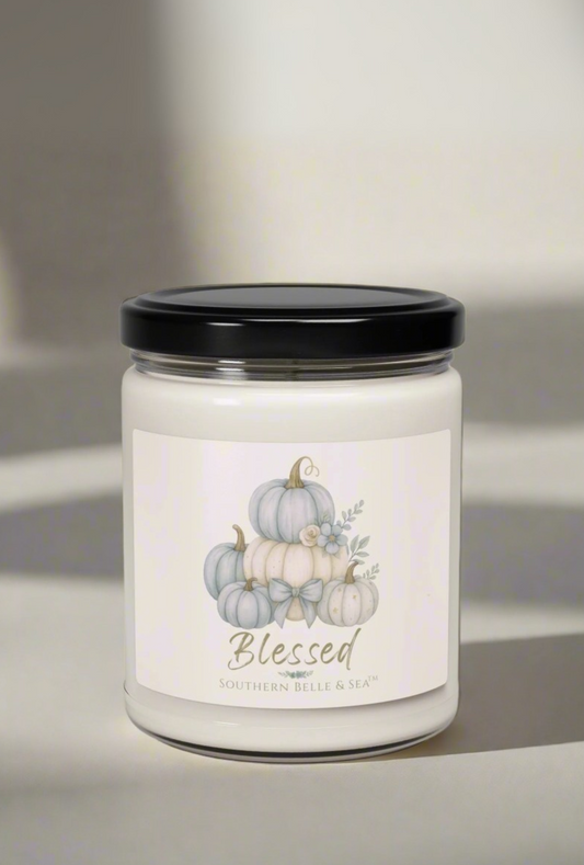 Candle labeled 'Autumn Vibes' with a gift box in front of a fireplace.