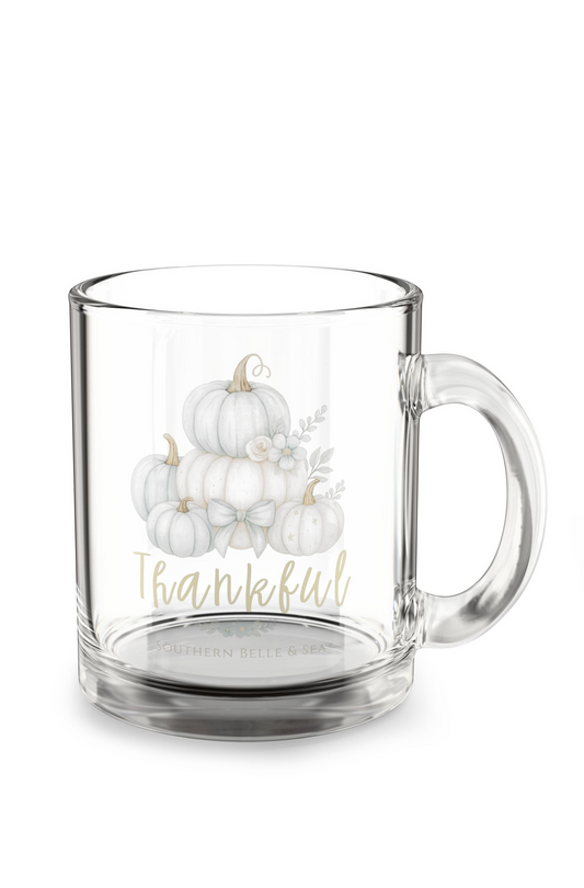 Clear glass mug with white pumpkins and 'Thankful' text on a white background