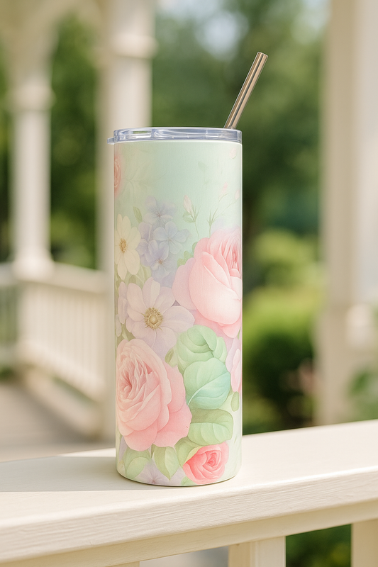 Southern Belle & Sea™ stainless steel tumbler featuring pastel rose and wildflower design, resting on a white porch railing in natural sunlight.